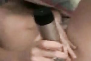 Playful and cheerful dark brown girlfriend playing with a dildo