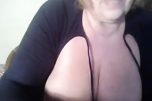 Mature golden-haired fattie plays with her mambos and slit in front of a web camera
