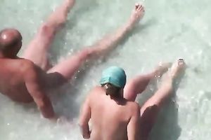 Slutty woman is giving her hubby a ideal tugjob on the beach