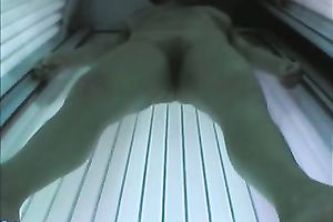 Hot blonde temptress tans her charming body in solarium