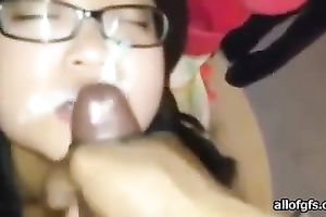 Four eyed Asian gal sucks her fuck buddy's 10-Pounder gently until this babe gets a facial