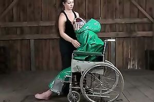 Lascivious nympho is placed into a wheeled restraint chair