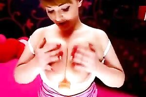 Amateur redhead plays with her enormous bumpers in webcam show