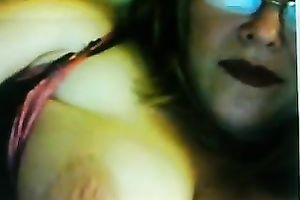 Lewd fair-haired milf licks her big jugs in front of a livecam