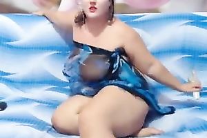 Sizzling dark brown big beautiful woman demonstrates her moist body for the livecam