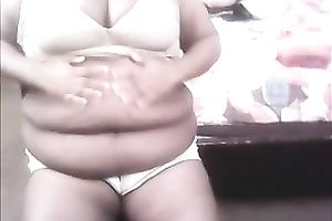 Plump bitch with large whoppers is rubbing her bulky abdomen for her online viewers
