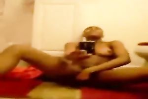 Stripping and masturbating ardently in front of a mirror