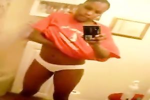Stripping and masturbating ardently in front of a mirror