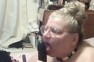 Old corpulent cam bitch in glasses sucks large marital-device on livecam