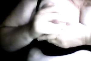 Full bosomed whore in glasses is engulfing her own nipples