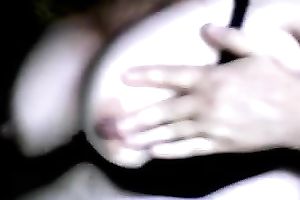 Full bosomed whore in glasses is engulfing her own nipples