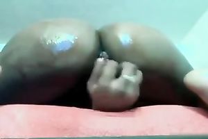 Ebony bitch with pierced navel bonks herself with her sex toy