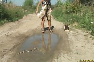 Blonde cutie with tanned skin pisses to the puddle