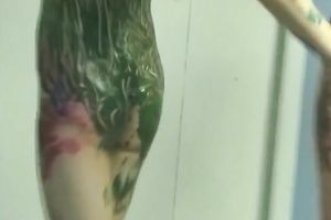 Two cute women smear each other's bodies with paints