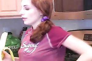 Redhead legal age teenager babe eats banana in the kitchen on livecam