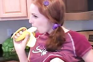 Redhead legal age teenager babe eats banana in the kitchen on livecam