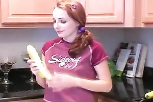 Redhead legal age teenager babe eats banana in the kitchen on livecam