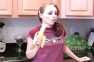 Redhead legal age teenager babe eats banana in the kitchen on livecam