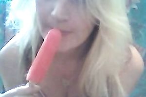 Blonde cutie sucks a popcicle and rubs her clit with it