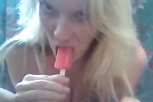 Blonde cutie sucks a popcicle and rubs her clit with it