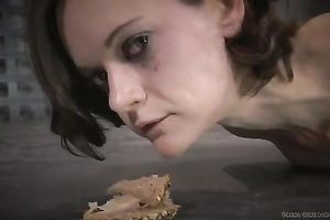 Hogtied dark brown whore eats her meal from the floor